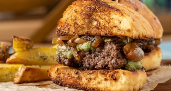 Caramelized,Onion,Burger,With,Avocado,Sauce,Cut,In,Half,,With